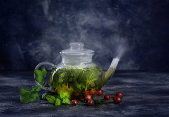 healthy green tea pot with tea leaves