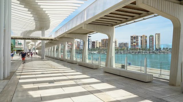 Beautiful gallery in Malaga harbour on a sunny summer day, Spain.