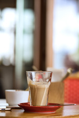 Large cup with latte on a table