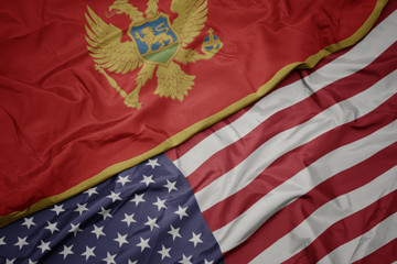 waving colorful flag of united states of america and national flag of montenegro. macro