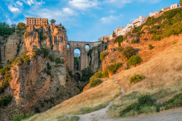 Ronda and its historic bridge in the late afternoon sun. Province of Malaga, Andalusia, Spain. - obrazy, fototapety, plakaty