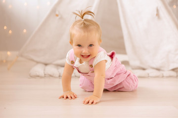 baby girl playing in the nursery, baby learning to walk, textiles for the nursery., tent in the children's room