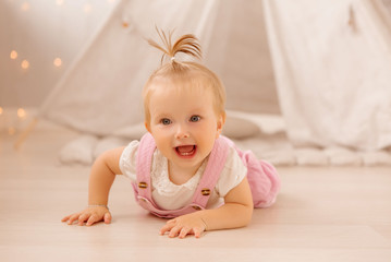 baby girl playing in the nursery, baby learning to walk, textiles for the nursery., tent in the children's room