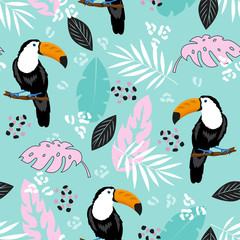 tropical leaves and toucan on blue background seamless pattern © StockVector