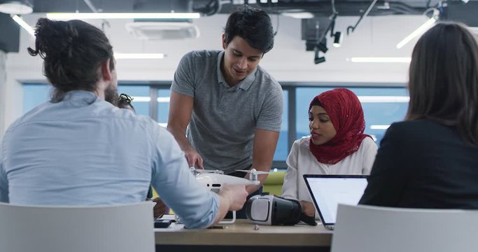 Young multiethnic business team of software developers working together using