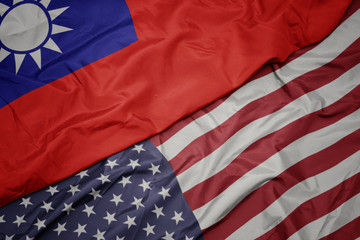 waving colorful flag of united states of america and national flag of taiwan.