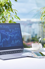 Modern workplace with a laptop on the background of the window close-up. Low depth of field as corporate background.