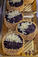 Set of chocolate mini cakes, with nuts and crumble chocolate on a confectionery showcase
