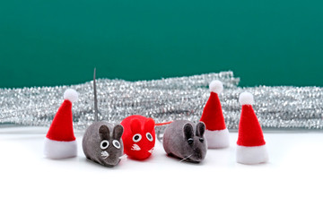 Three rats, 2 gray and 1 red.A cute rat in a red Santa hat. year of rat. Postcard happy new year...