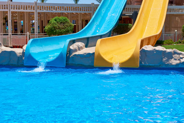 Two water slides in aqua park. Background of water park