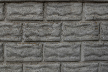 a concrete fence a departure in the form of a bricklaying is covered with dirt and moss from time...