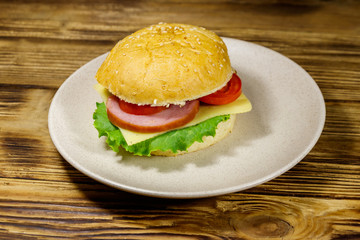Fresh delicious homemade cheeseburger on wooden table