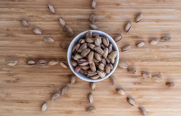 Pistachios in a white cup in the form of the sun