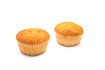 two Christmas cupcakes in pink, decorated with yellow and pink stars and a candy stick on the top, on a white background.