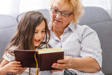Grandmother and granddaughter reading