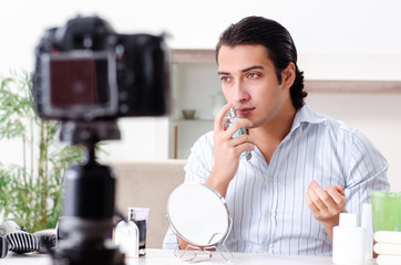 Young handsome man recording his blog in hygiene concept