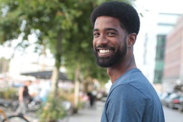 Beautiful happy man outside in the park