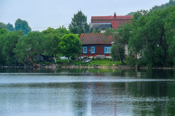 Fototapeta na wymiar Sebezh, Russia - May, 25, 2019: Rural houses by the lake in Sebezh, Russia