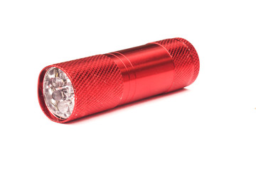 red plastic flashlight isolated on white background.