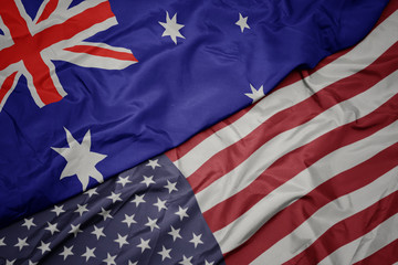 waving colorful flag of united states of america and national flag of australia.