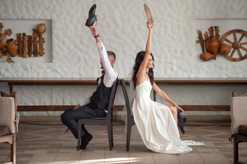 Funny wedding couple having fun at restaurant