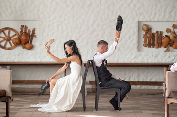 Funny wedding couple having fun at restaurant