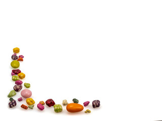 Candies are patterned. Sweet food. Caramel dragees, pebbles, stones. On a white background, isolated. Still life.