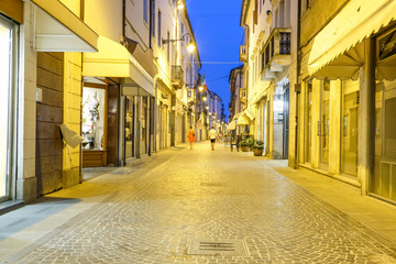 Adria, Italy - July, 11, 2019: one of the central streets of Adria, Italy, in the evening - obrazy, fototapety, plakaty