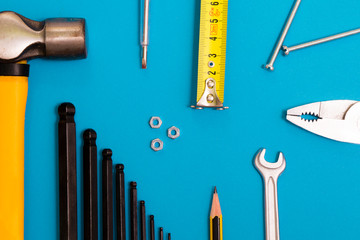 Work tools on blue background. top view