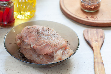raw chicken meat with spices at kitchen table. chicken chops. selective focus. cooking chops.