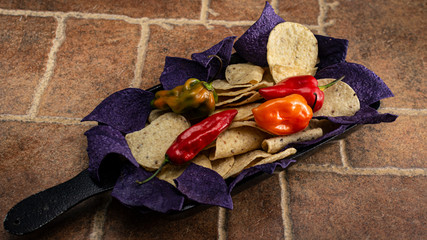 Purple corn nachos, chili peppers, green chili peppers, orange, red