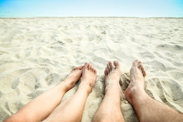 beautiful legs in the sand of the sea greece background
