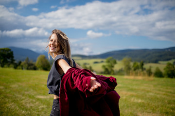 Young woman in red shirt have a fun in a mountains