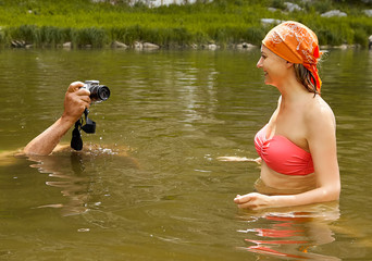Taking photos of smiling woman in water.