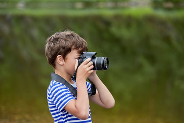 Fototapeta na wymiar White boy is shooting nature.