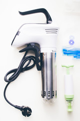 Sous vide stick or rooner close up, top view of a modern utensil for the sous vide cooking technique, ooner,  precision immersion circulator. Isolated on clean background. 
