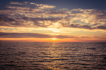 Beautiful sky with clouds at sunset over Adriatic sea near Peschici town on Gargano peninsula, Italy