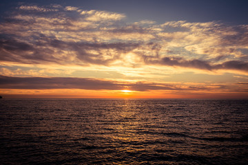 Beautiful sky with clouds at sunset over Adriatic sea near Peschici town on Gargano peninsula, Italy