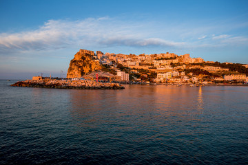 Setting sun lit city over the sea