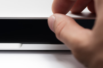 Hands closing and shutting down the notebook. Office work.