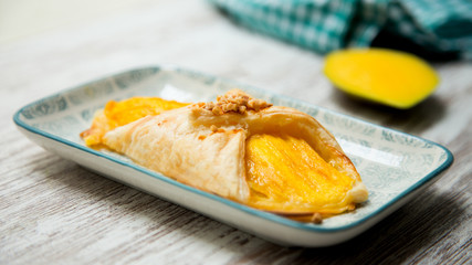 Mango dessert with almonds
