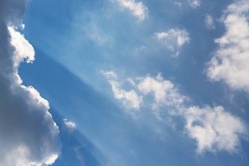 Beautiful white fluffy clouds on a sky background. Sunlight, light and shadow