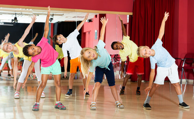 Boys and girls having dancing class in studio