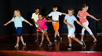 Children studying modern style dance in class