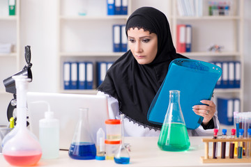 Female chemist in hijab working in the lab