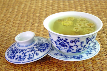 Chrysanthemum tea. Chinese tradition chrysanthemum tea in beautiful blue and white porcelain cup, famous herbal tea from Huangshan , Anhui China. Selective focus, space for texts