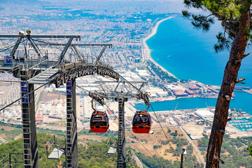 View on the cable car with orange cable cars and Antalya in Turkey. - obrazy, fototapety, plakaty