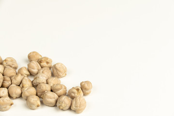 Dry raw organic chickpeas isolated on white background.