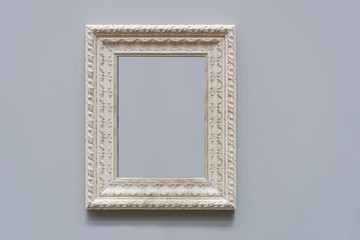 Antique white photo frame interior decoration on gray color wall background with blank for copy...