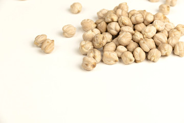 Dry raw organic chickpeas isolated on white background.